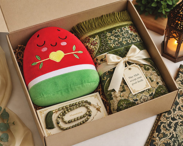 Nūr in a sponsor gift box with a prayer mat and prayer beads