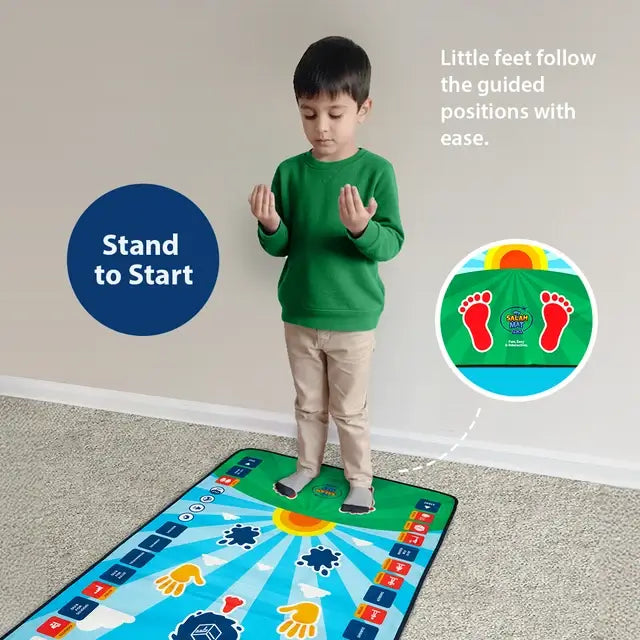Boy in a green jumper standing with raised hands at the footprints of the Kids Interactive Prayer Mat (Blue)