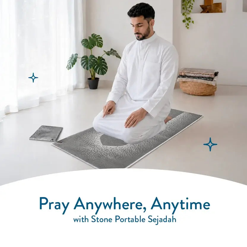 Man in a white robe kneeling on the Stone pocket prayer mat in a bright room