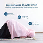 Woman in a pink prayer garment in sujood on the Spring Blossoms padded prayer mat, cushioning knees and forehead