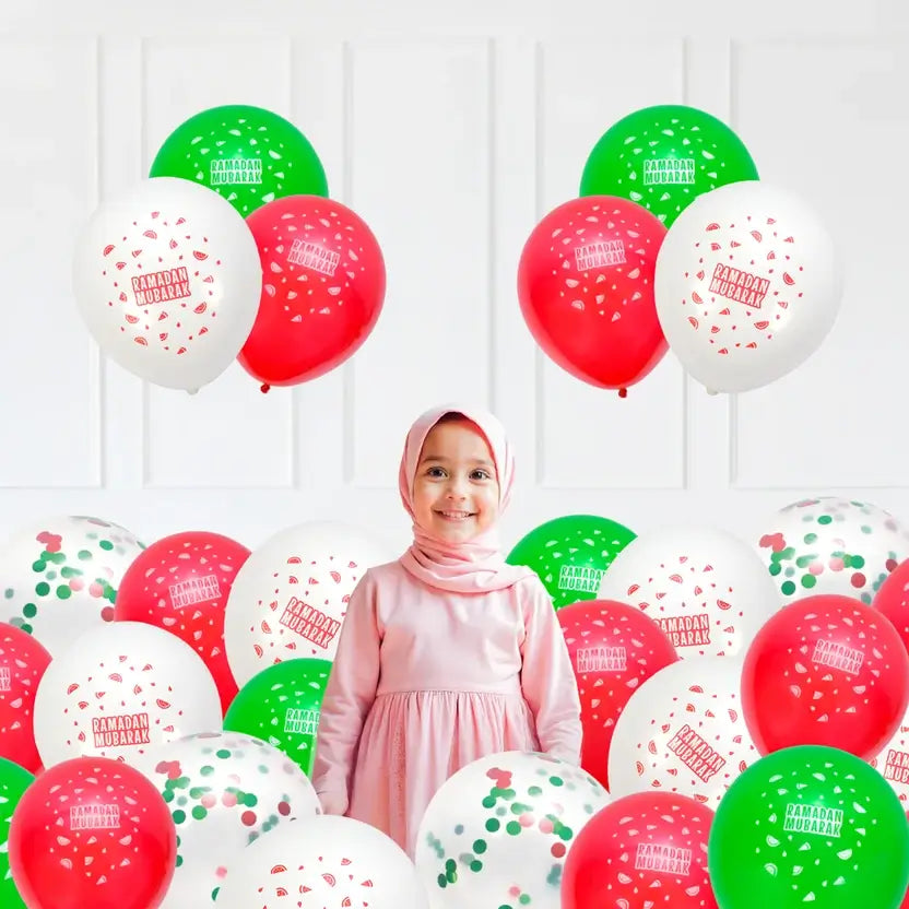 Girl in a pink hijab surrounded by red, green, white and confetti Ramadan Mubarak latex balloons