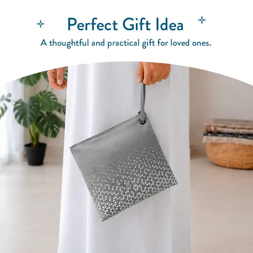 Person in a white robe holding the detachable pouch of the Stone pocket prayer mat by its strap