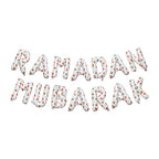 Loose white watermelon-print foil letters spelling Ramadan Mubarak on a plain background