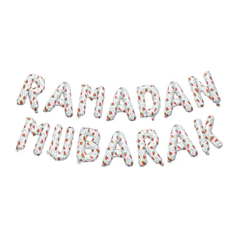 Loose white watermelon-print foil letters spelling Ramadan Mubarak on a plain background