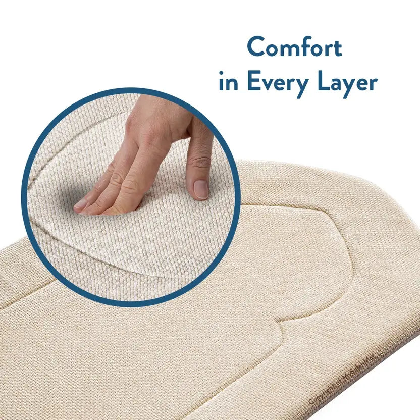 Hand pressing the soft woven fabric of the Luxury Sand Arched padded prayer mat in a close-up circle