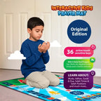 Boy in a blue jumper kneeling with raised hands in dua on the Kids Interactive Prayer Mat (Blue)
