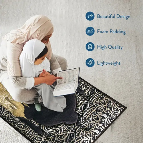 Woman in a hijab and a girl reading a book together on the Dark Arabic Calligraphy padded prayer mat