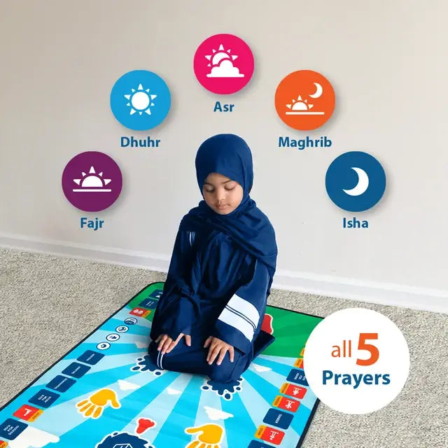 Girl in a navy hijab kneeling on the Kids Interactive Prayer Mat (Blue), with icons for the five daily prayers