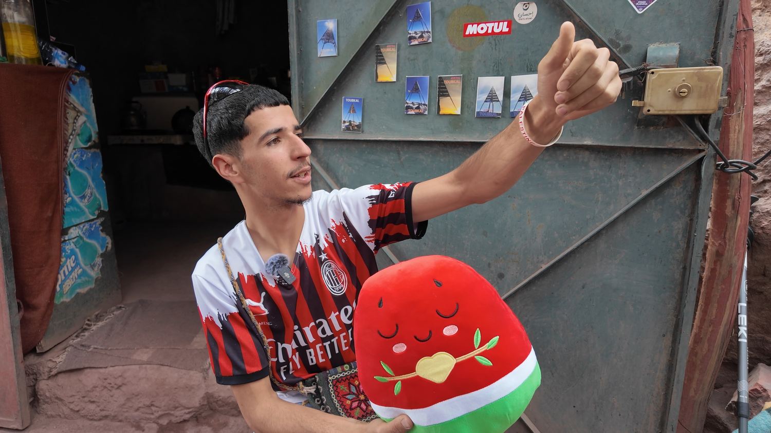A young man in Morocco holding the N&umacr;r plushie