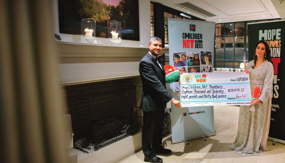 Kamal Ali of My Salah Mat handing a cheque for &pound;18,078.32 to Children Not Numbers