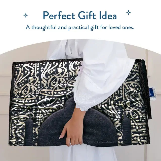 Folded Dark Arabic Calligraphy padded prayer mat carried in both arms, shown as a gift idea