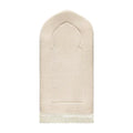 Luxury Sand Arched padded prayer mat from the front, cream woven fabric with an arch outline and white tassels
